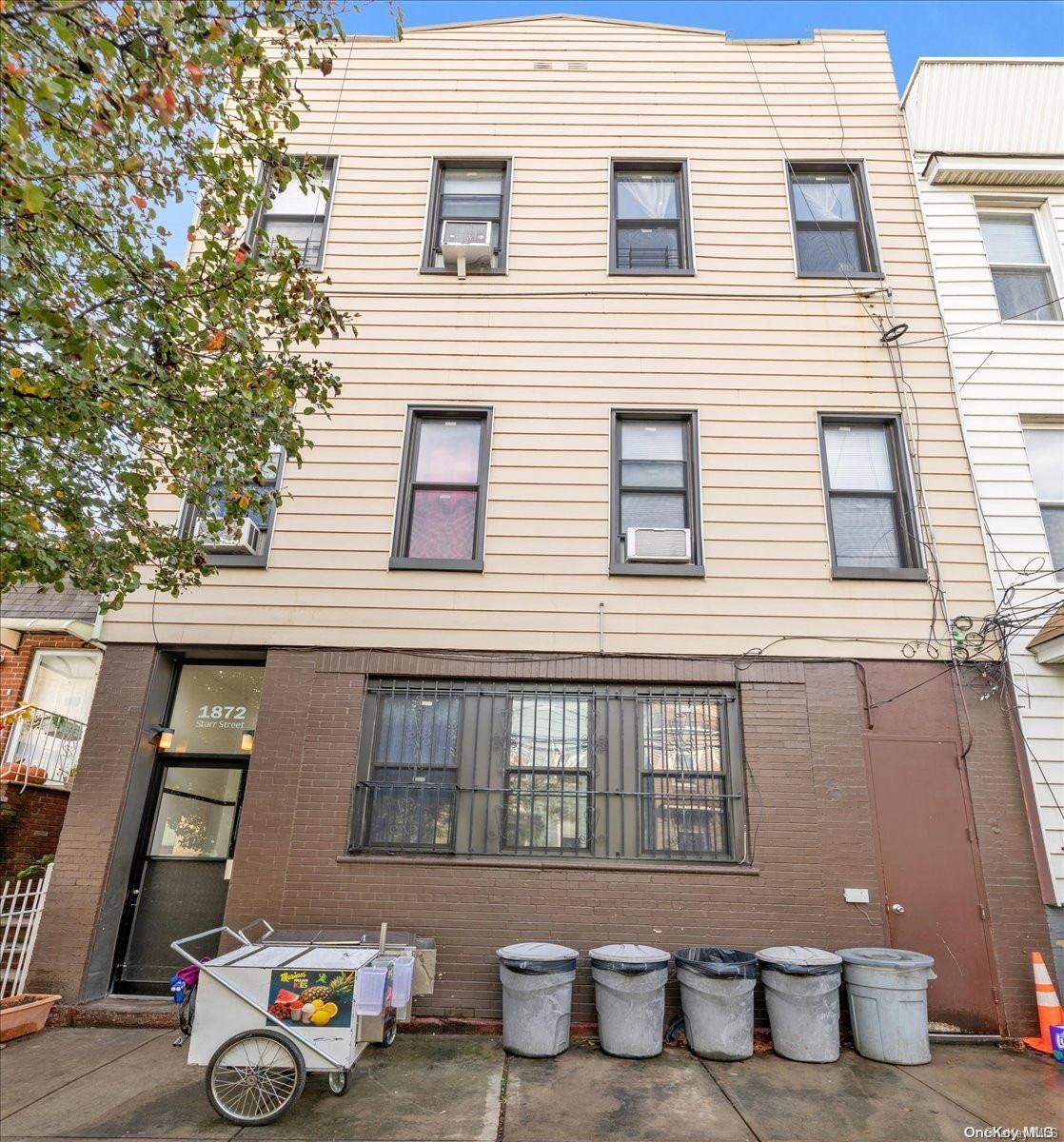 18-72 Starr Street Queens, NY 11385 - Photo 1 of 1 a front view of a house with many windows