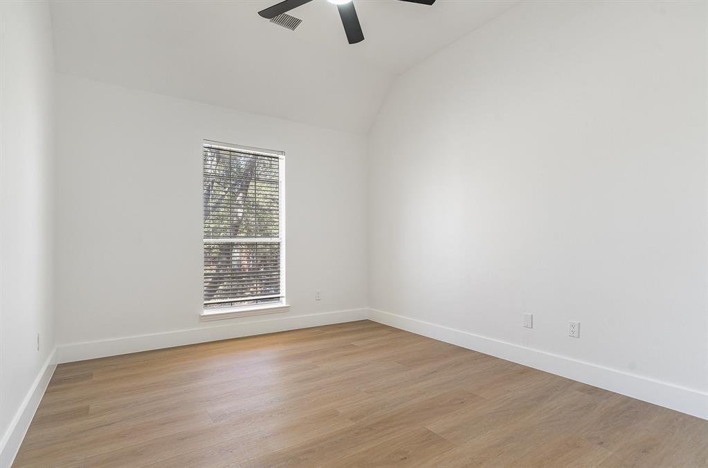7524 Aberdon Road Dallas, TX 75252 - Photo 24 of 39 Unfurnished room with light wood-type flooring, lofted ceiling, and baseboards