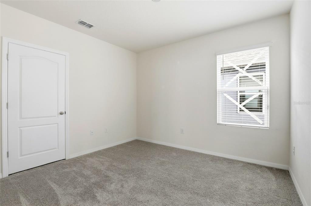 6777 Huntleigh Hammock Road Harmony, FL 34773 - Photo 17 of 32 an empty room with windows