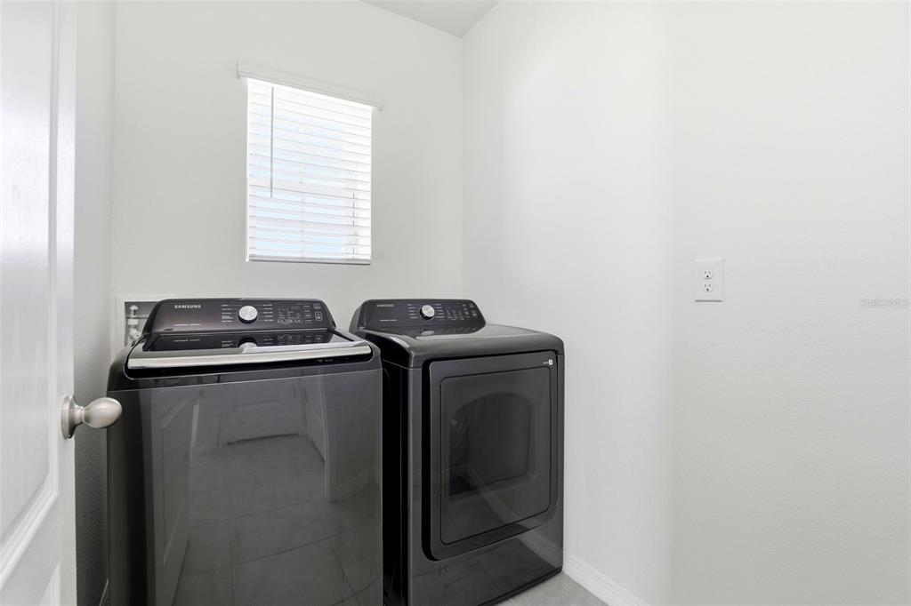 6777 Huntleigh Hammock Road Harmony, FL 34773 - Photo 23 of 32 a utility room with dryer and washer