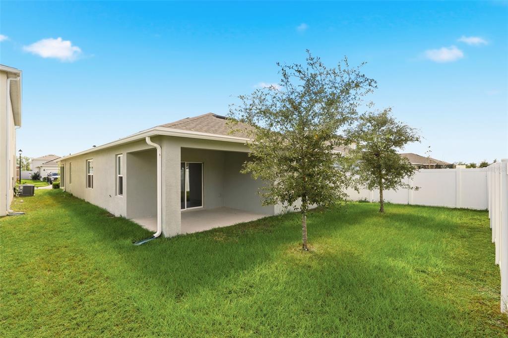 6777 Huntleigh Hammock Road Harmony, FL 34773 - Photo 26 of 32 a view of a house with a yard