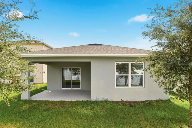 a view of the house with a yard