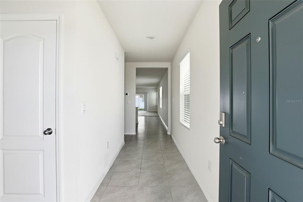 6777 Huntleigh Hammock Road Harmony, FL 34773 - Photo 4 of 32 a view of a hallway with a wooden floor
