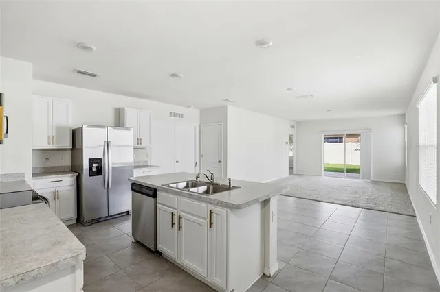 a kitchen that has a stove a refrigerator and a sink