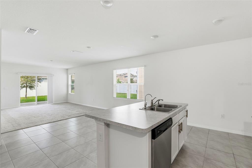 6777 Huntleigh Hammock Road Harmony, FL 34773 - Photo 7 of 32 a kitchen with a sink cabinets and window