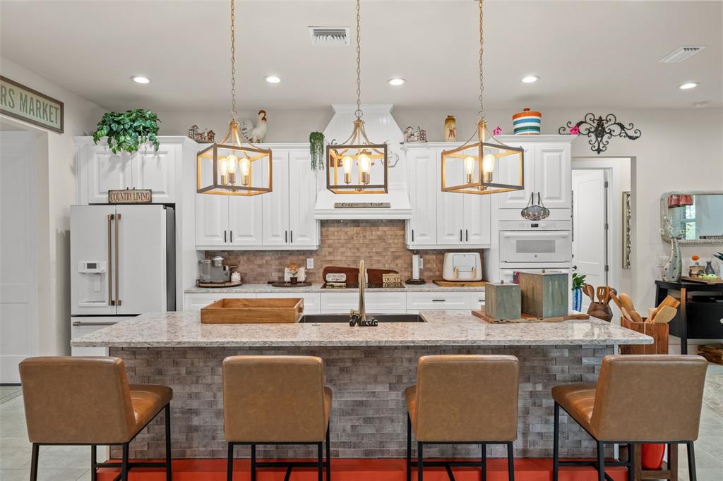 17601 Hanna Road Lutz, FL 33549 - Photo 12 of 48 a kitchen with granite countertop a table and chairs in it