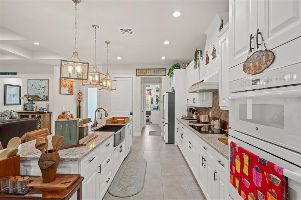17601 Hanna Road Lutz, FL 33549 - Photo 14 of 48 a kitchen with stainless steel appliances kitchen island granite countertop a stove a sink and a refrigerator