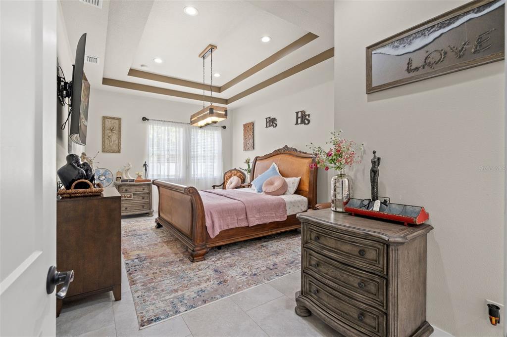 17601 Hanna Road Lutz, FL 33549 - Photo 21 of 48 a bedroom with furniture and a bed