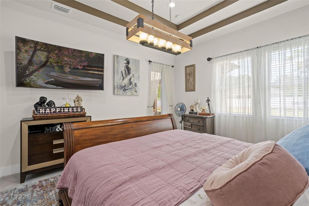 17601 Hanna Road Lutz, FL 33549 - Photo 22 of 48 a bedroom with a bed and a flat screen tv