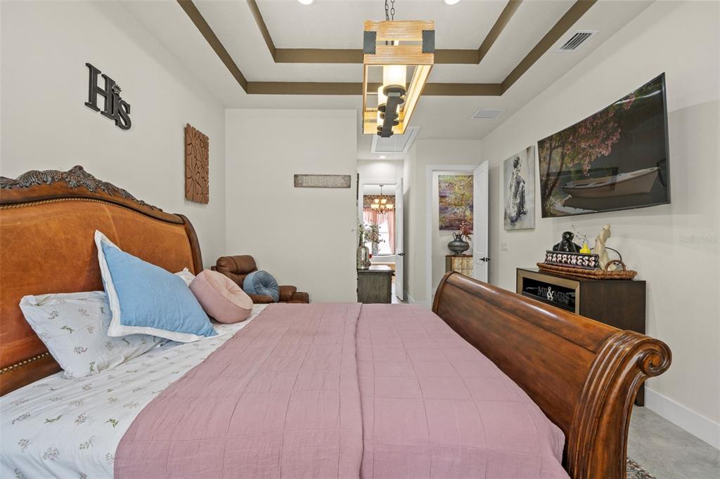 17601 Hanna Road Lutz, FL 33549 - Photo 23 of 48 a bedroom with a bed and flat screen tv