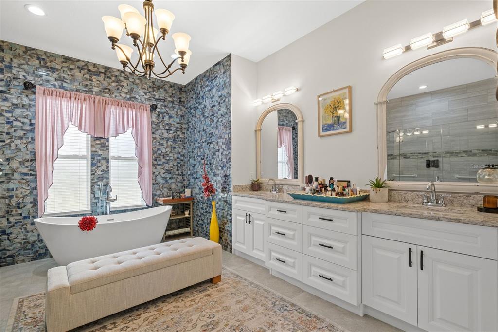17601 Hanna Road Lutz, FL 33549 - Photo 26 of 48 a bathroom with a granite countertop sink mirror and bathtub