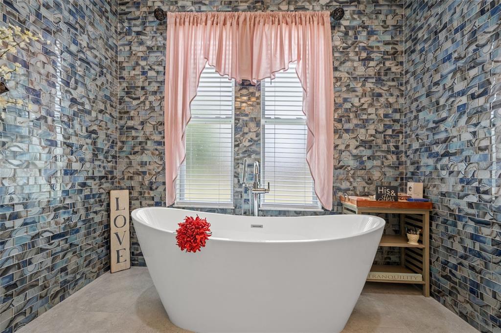 17601 Hanna Road Lutz, FL 33549 - Photo 27 of 48 a bathroom with a bathtub and a shower
