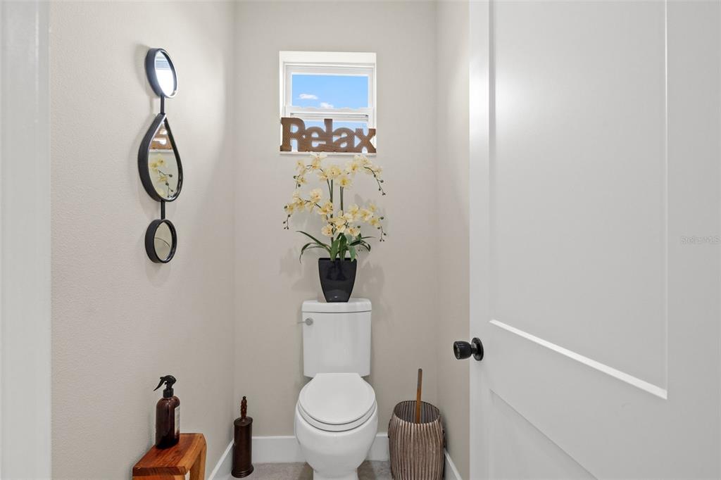 17601 Hanna Road Lutz, FL 33549 - Photo 29 of 48 a bathroom with a toilet and a mirror