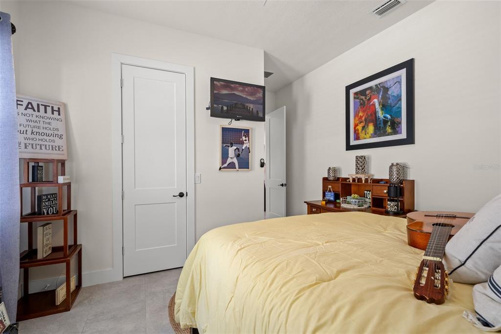 17601 Hanna Road Lutz, FL 33549 - Photo 31 of 48 a bedroom with a bed and a workspace