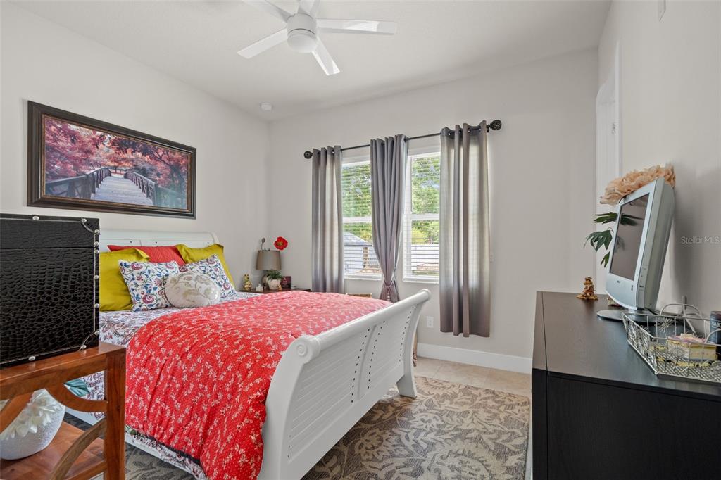 17601 Hanna Road Lutz, FL 33549 - Photo 33 of 48 a bedroom with a bed and a flat screen tv