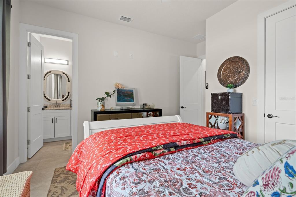 17601 Hanna Road Lutz, FL 33549 - Photo 34 of 48 a bedroom with a bed and a chandelier