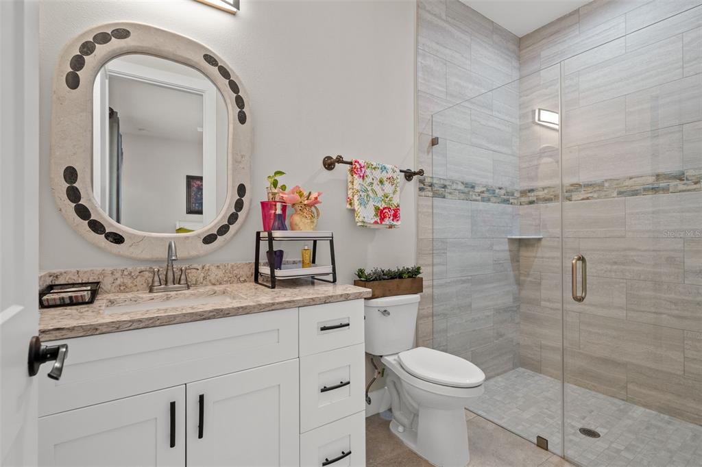 17601 Hanna Road Lutz, FL 33549 - Photo 35 of 48 a bathroom with a granite countertop toilet sink and mirror