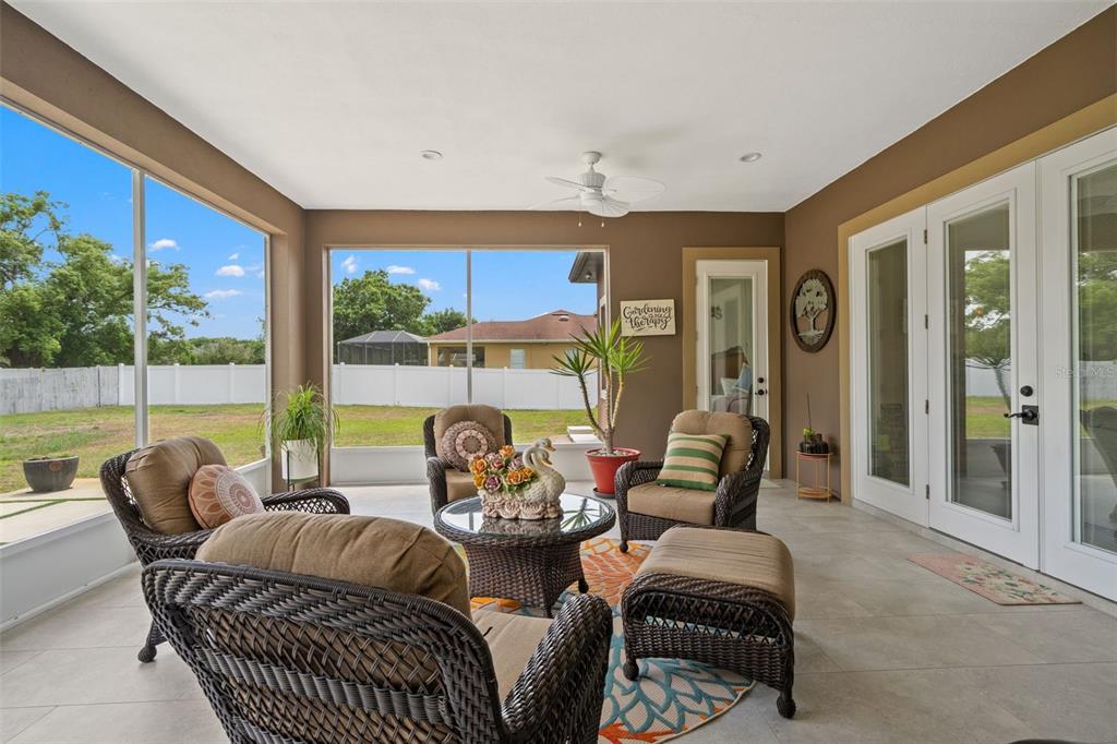 17601 Hanna Road Lutz, FL 33549 - Photo 39 of 48 a outdoor living space with furniture and a floor to ceiling window