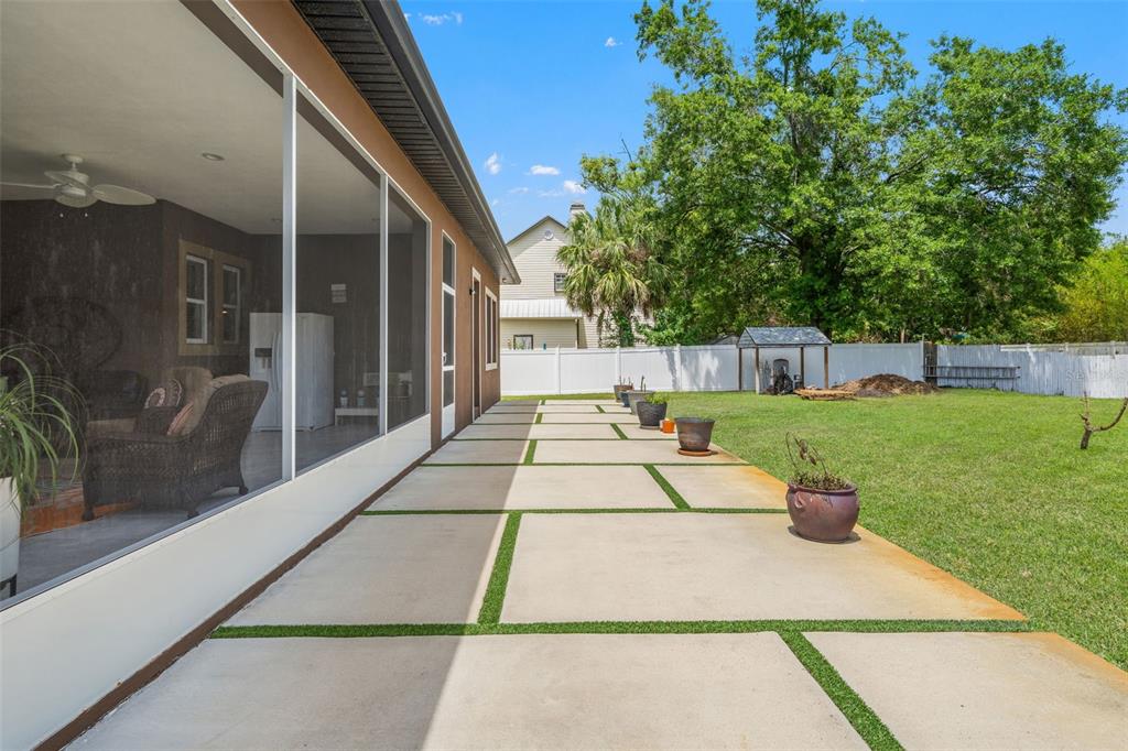17601 Hanna Road Lutz, FL 33549 - Photo 40 of 48 a view of a patio with table and chairs and potted plants