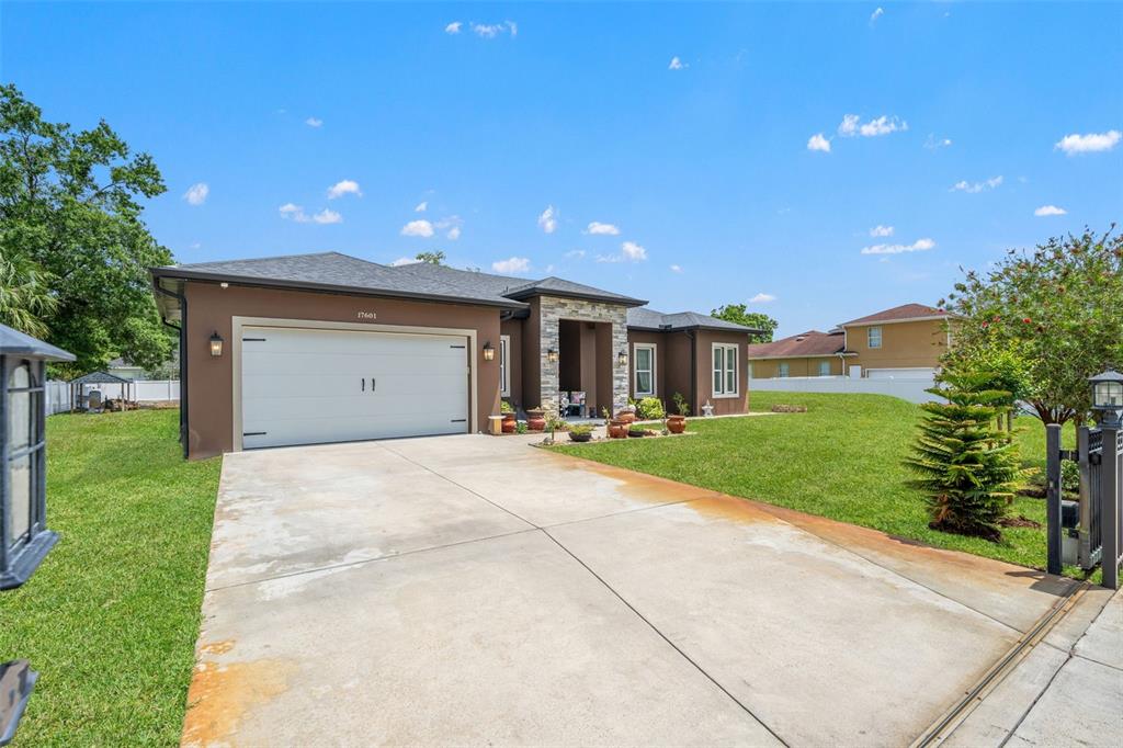 17601 Hanna Road Lutz, FL 33549 - Photo 4 of 48 a view of a house with a yard and garage