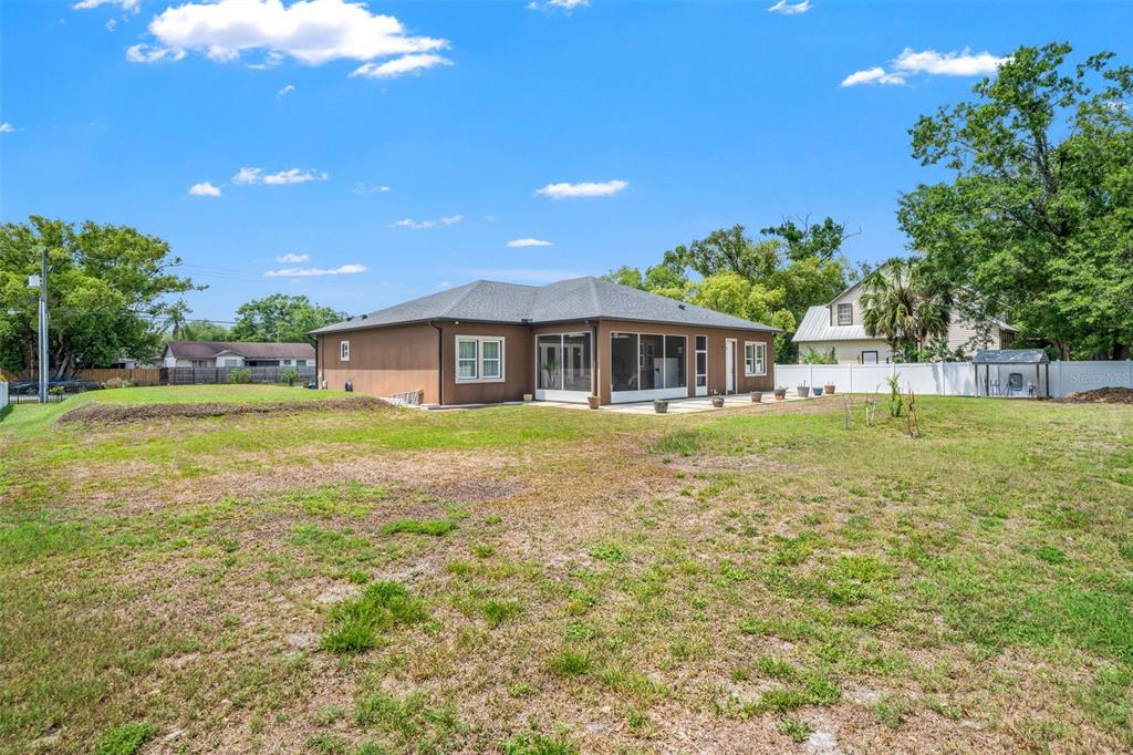17601 Hanna Road Lutz, FL 33549 - Photo 47 of 48 a view of a house with a yard