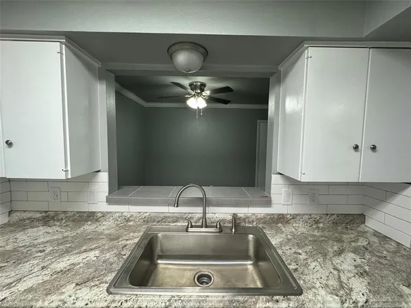 a kitchen with a sink and cabinets