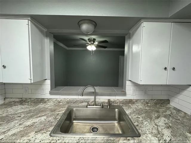 a kitchen with a sink and cabinets