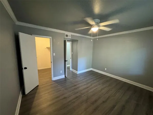 an empty room with wooden floor and door