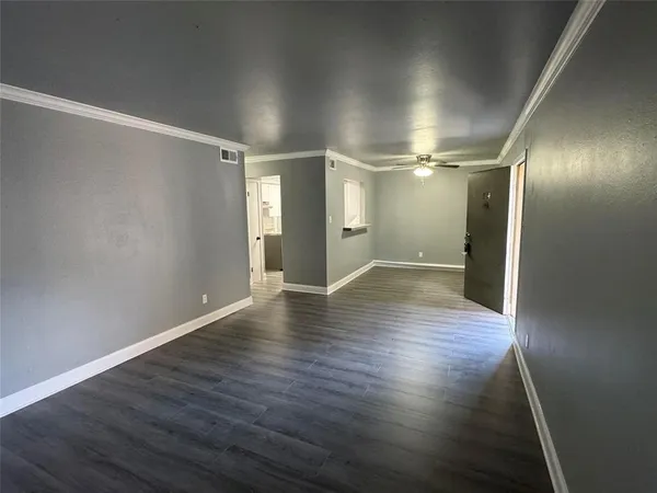 a view of a room with wooden floor
