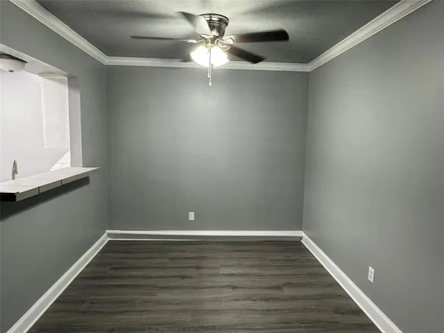 a view of room with window and wooden floor