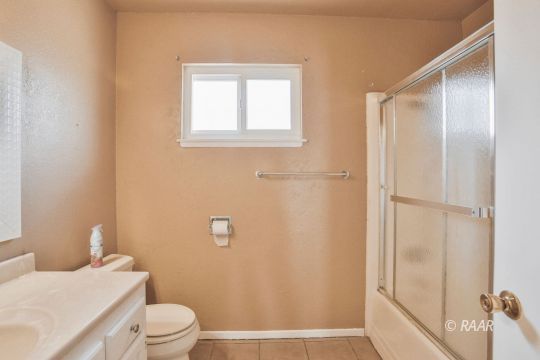 1144 West St George Avenue Ridgecrest, CA 93555 - Photo 13 of 18 a bathroom with a granite countertop sink toilet and shower