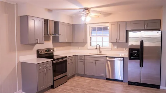 a kitchen with a sink appliances and cabinets