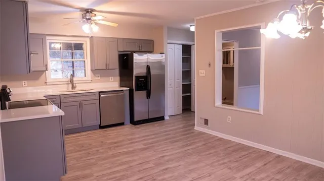a kitchen with stainless steel appliances a refrigerator and a sink