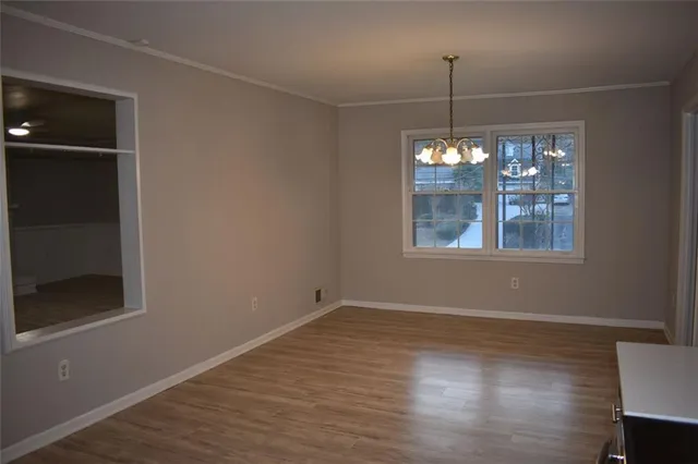 a room that has a window and wooden floor