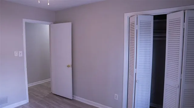 a view of closet area with wooden floor
