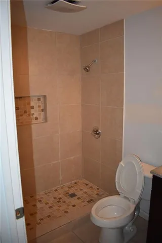 a bathroom with a toilet and a shower