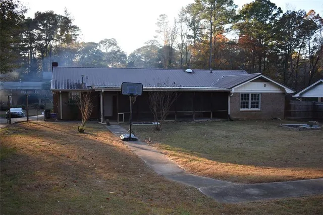 a view of a house with a yard and sitting area