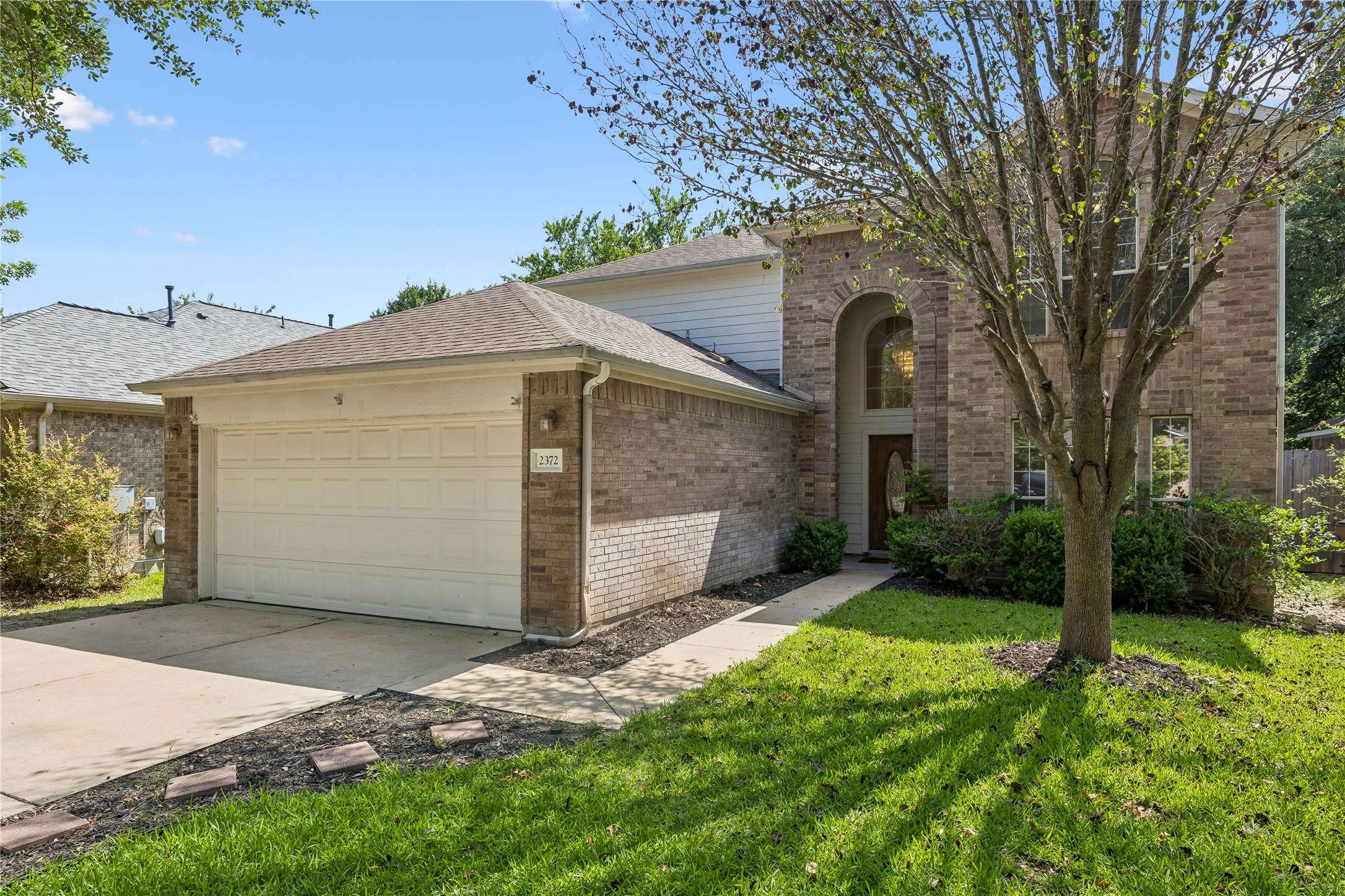 2372 Paradise Ridge Drive Round Rock, TX 78665 - Photo 2 of 40 A classic brick exterior with an arched entryway and inviting green landscaping awaits your arrival.