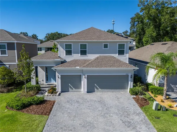 a front view of a house with a yard and a garage