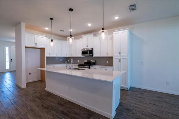 a kitchen with a sink and a stove top oven