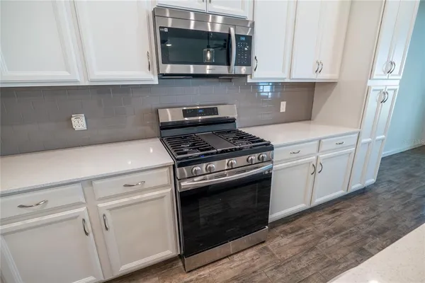 a kitchen with sink and microwave
