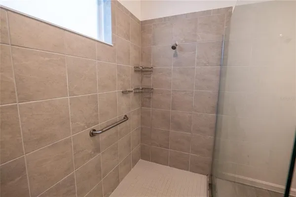 a bathroom with a double vanity sink toilet mirror and bathtub
