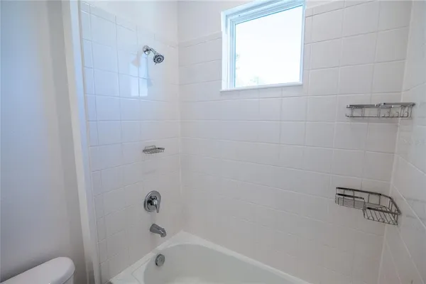 a front view of a house with a yard and potted plants