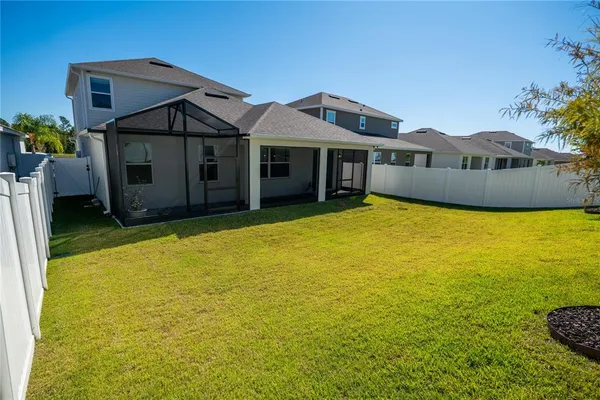 a view of a backyard with wooden fence