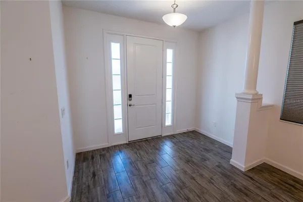a view of entryway and hall with wooden floor
