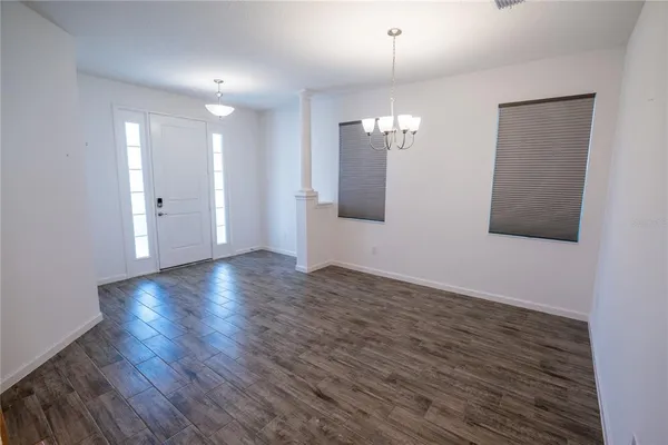 a view of kitchen with stainless steel appliances granite countertop a sink a refrigerator and a stove