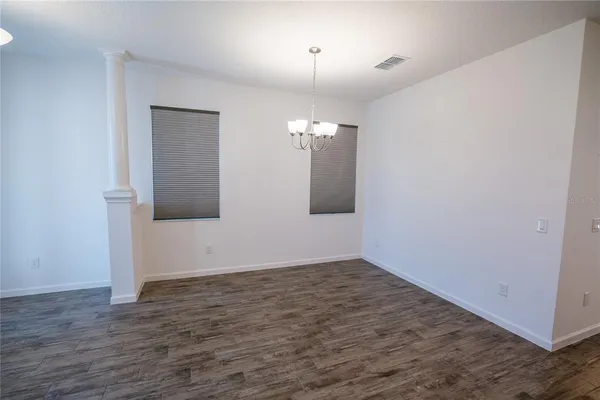a kitchen with granite countertop white cabinets and stainless steel appliances