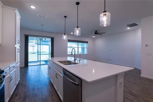 a kitchen with sink cabinets and wooden floor