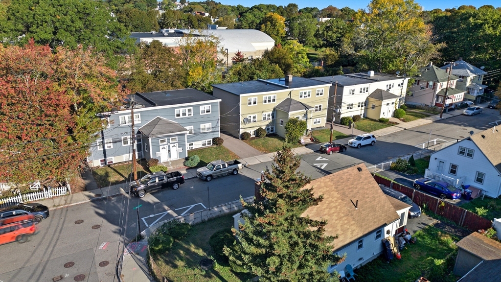 157-167 Delhi Street Boston, MA 02126 - Photo 1 of 16 an aerial view of a house with a garden