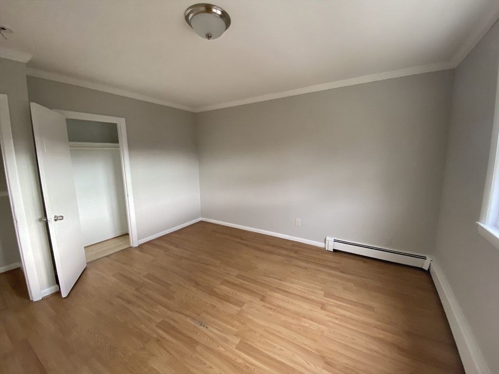 157-167 Delhi Street Boston, MA 02126 - Photo 11 of 16 a view of empty room with wooden floor